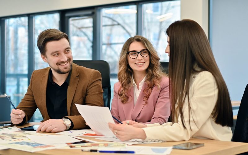 Business meeting in an office, workers discussing business affairs using papers with charts
