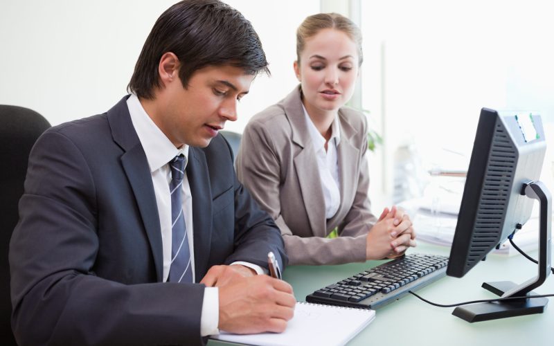 Serious business people working with a computer in an office